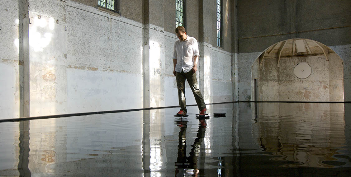 Link to Bridge by Michael Cross. image shows a man walking on water on steps.