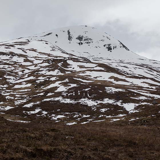 Melt by Michael Cross. Giant letters acb made of smow on a hillside.