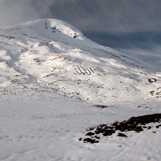 Melt by Michael Cross. Giant letters acb made of smow on a hillside.